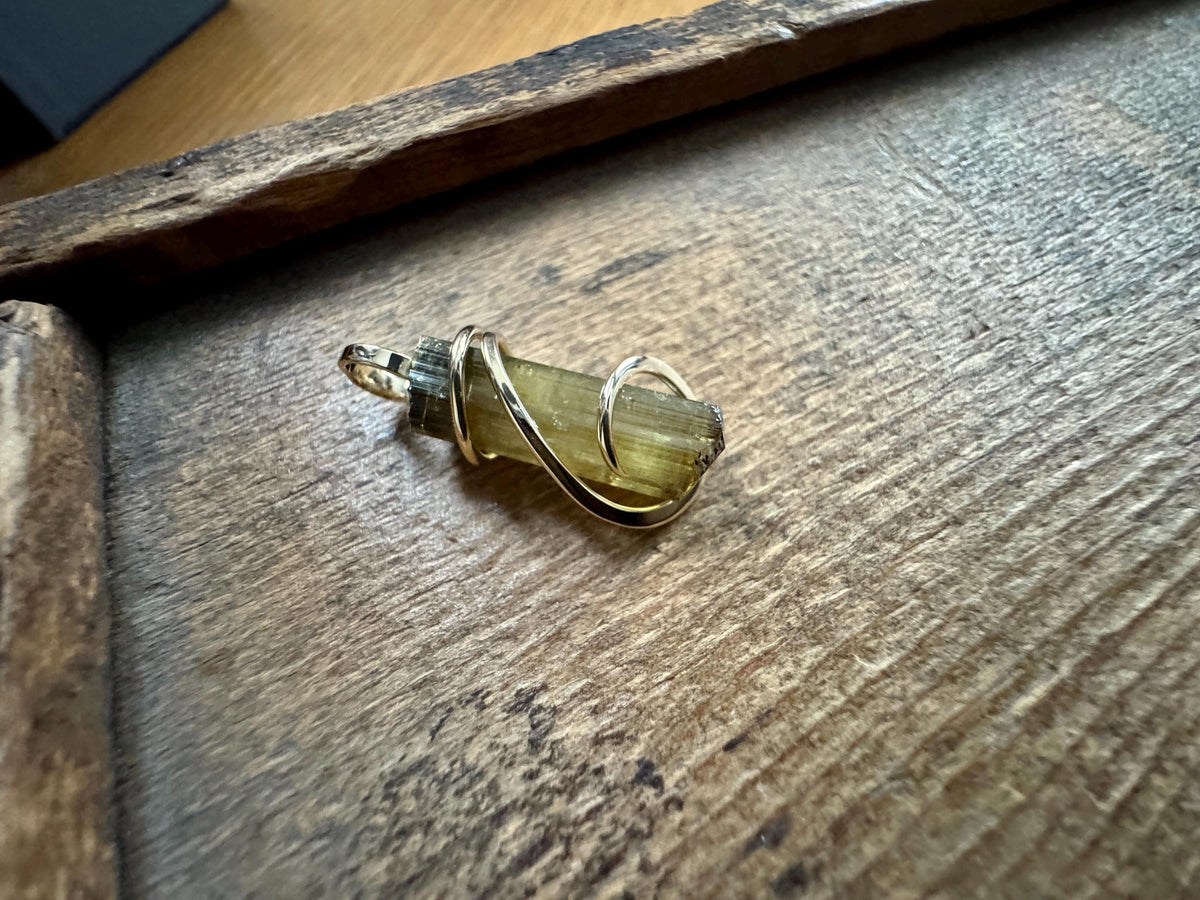 Yellow tourmaline crystal in 14k gold pendant