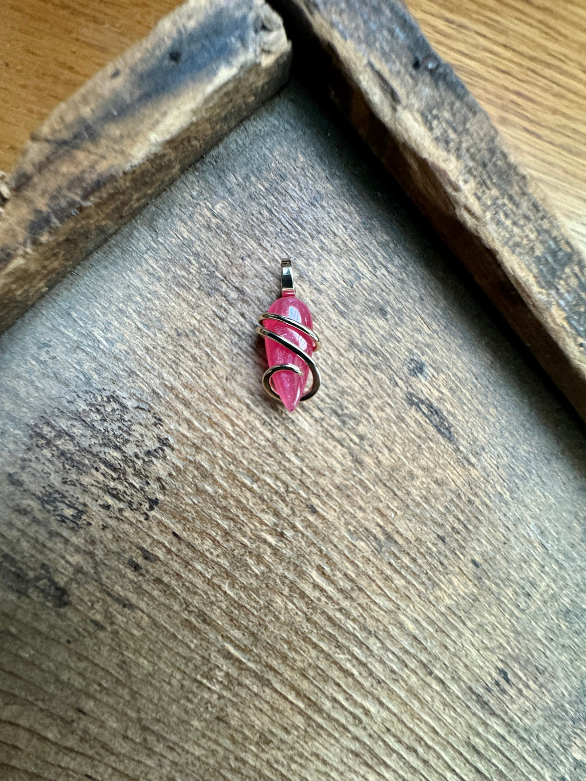Faceted rhodonite in 14k gold pendant