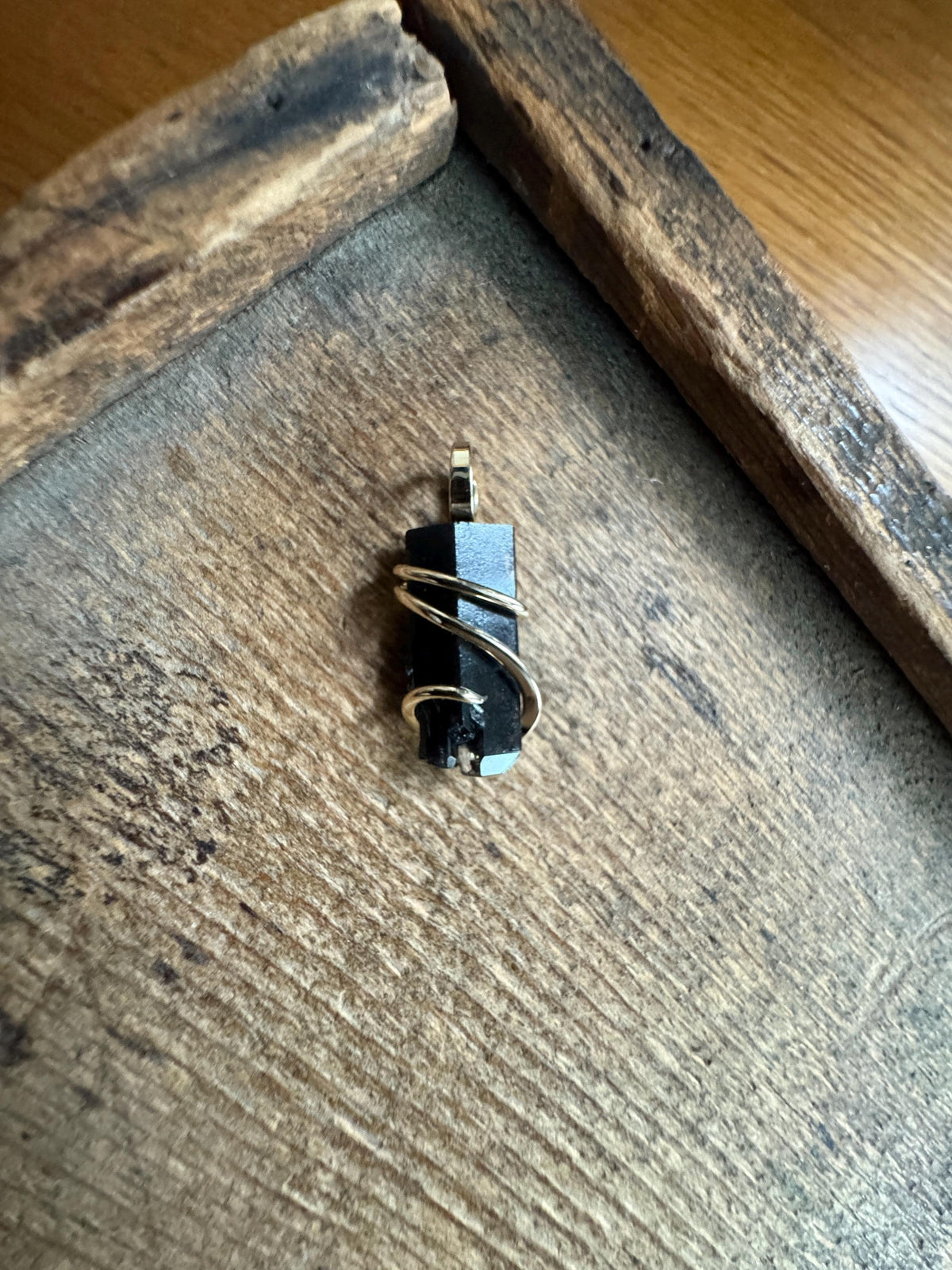 Black topaz crystal in 14k gold pendant