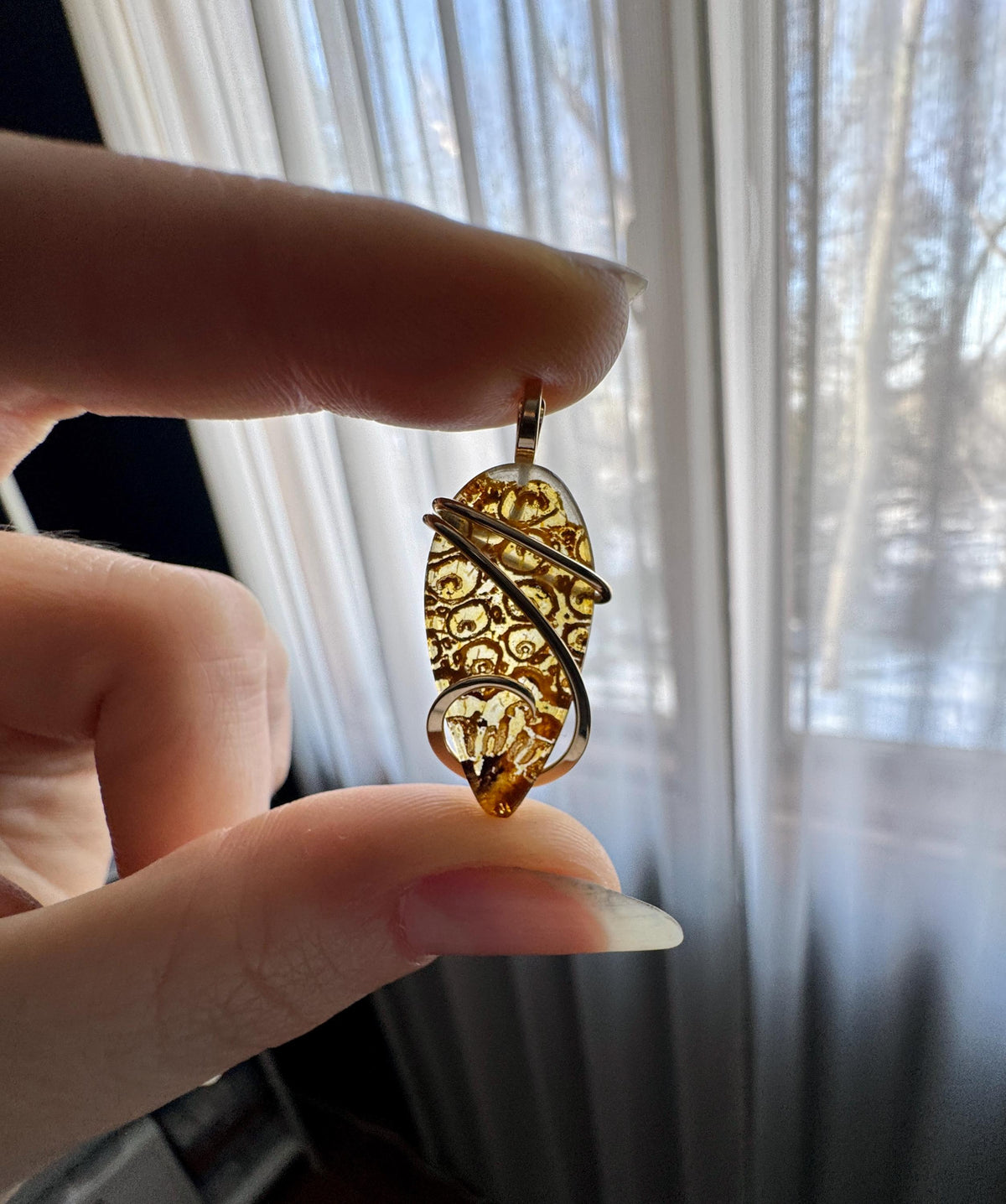 Fern fossil in 14k gold pendant