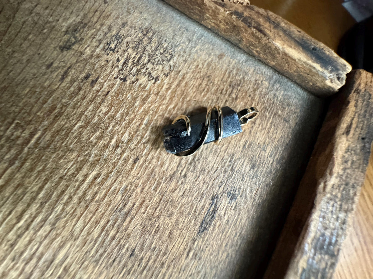 Black topaz crystal in 14k gold pendant