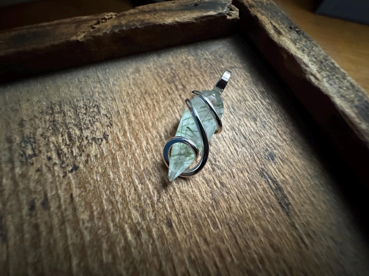 Faceted tourmalinated quartz in sterling silver pendant