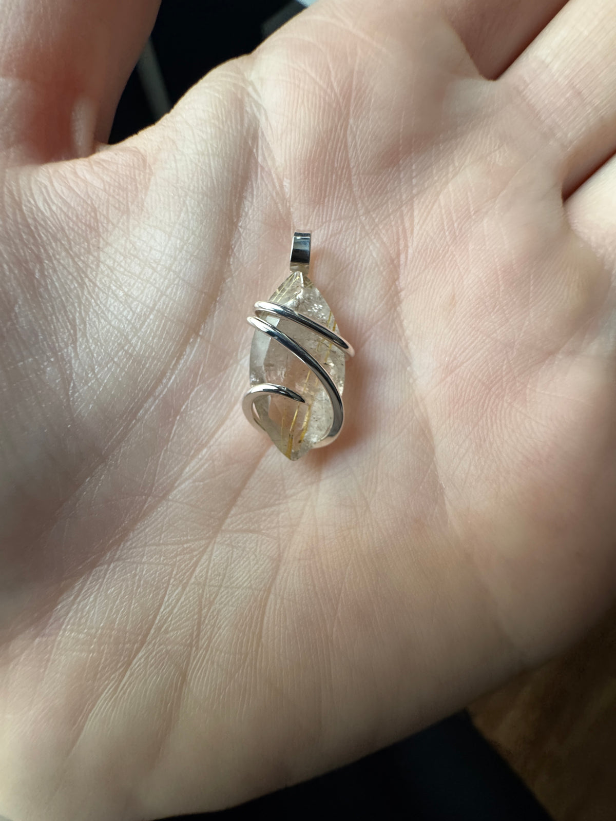 Faceted rutilated quartz in sterling silver pendant