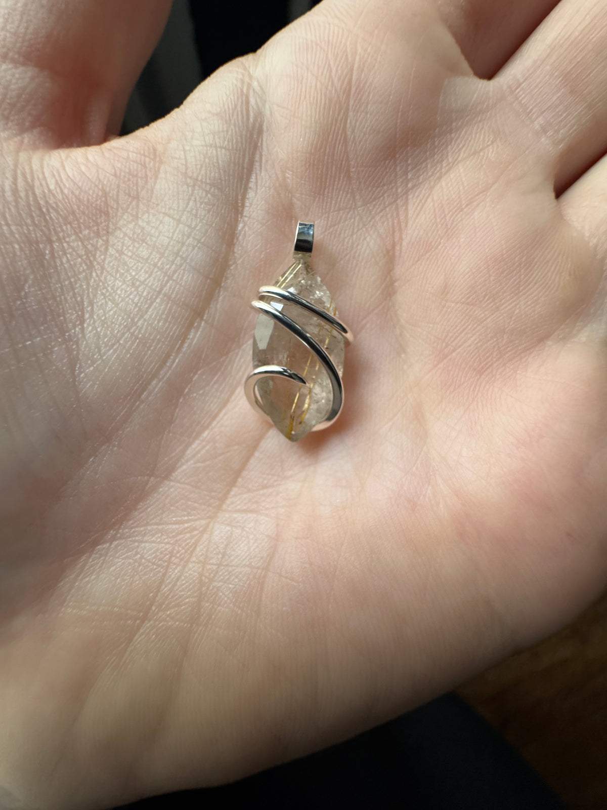 Faceted rutilated quartz in sterling silver pendant