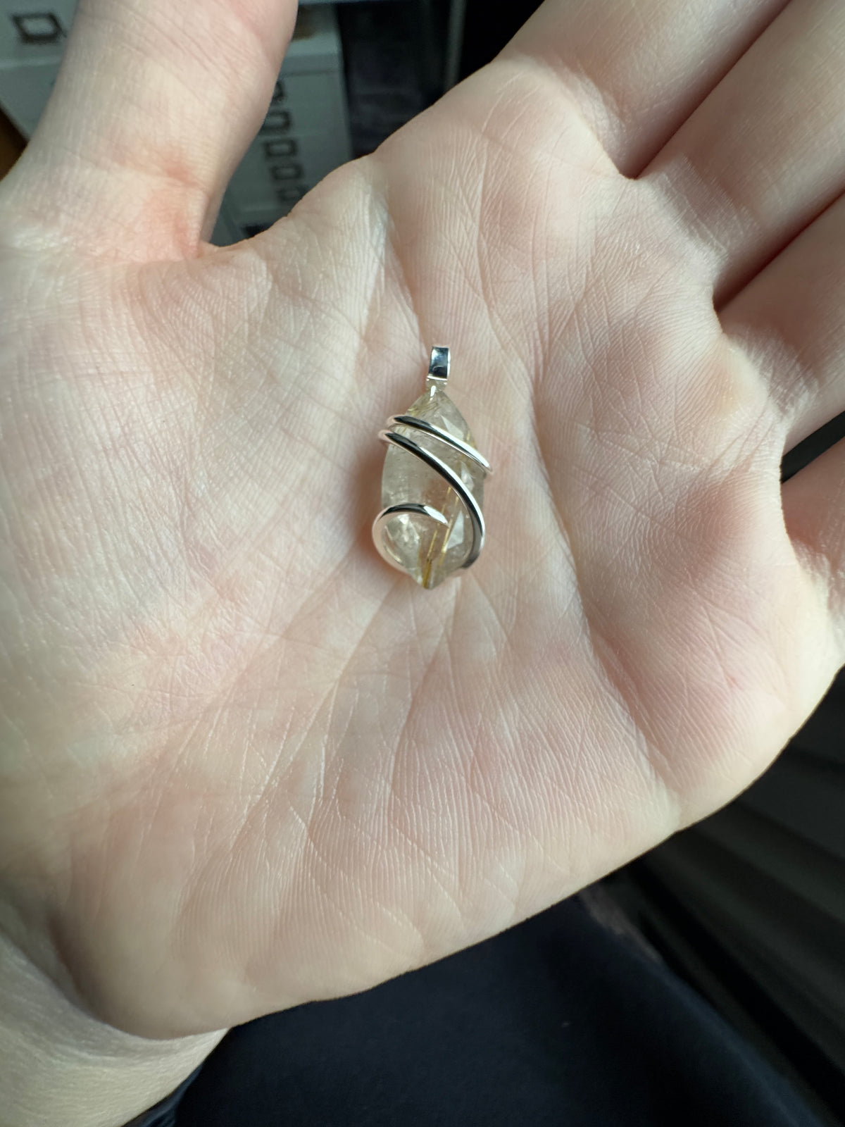 Faceted rutilated quartz in sterling silver pendant