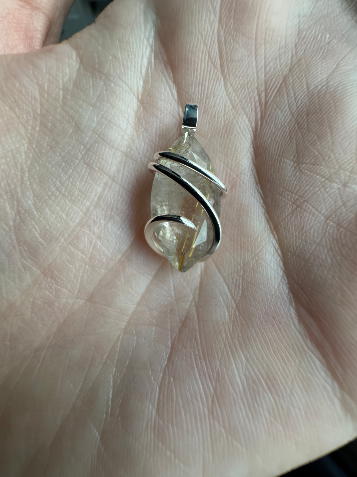 Faceted rutilated quartz in sterling silver pendant