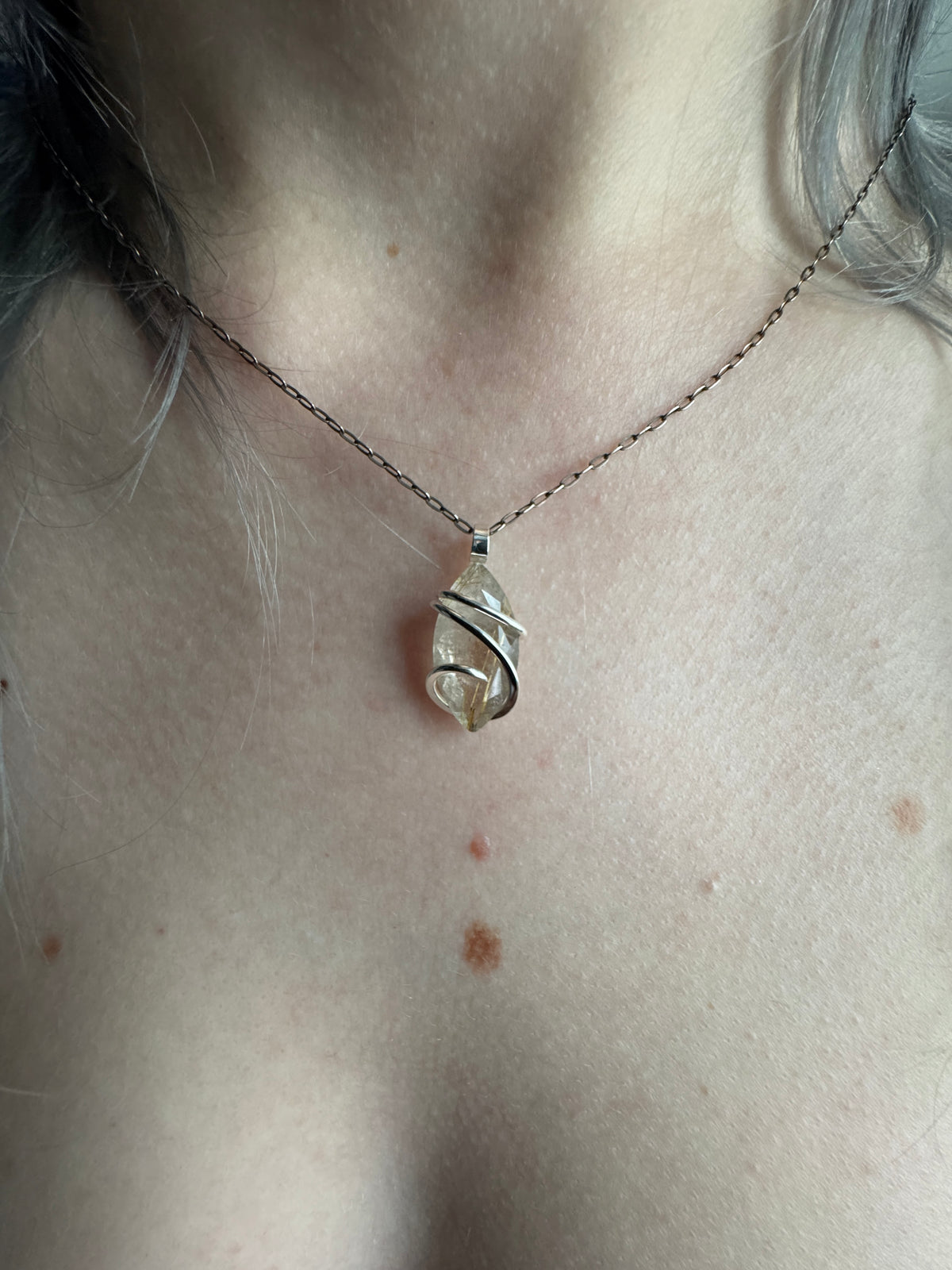 Faceted rutilated quartz in sterling silver pendant