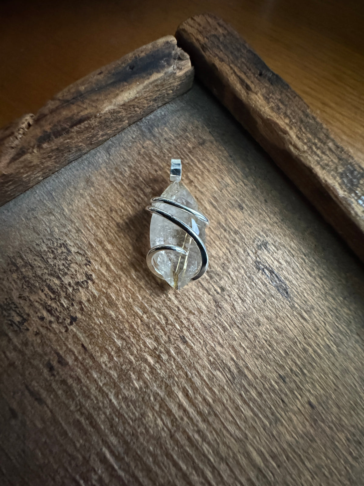 Faceted rutilated quartz in sterling silver pendant