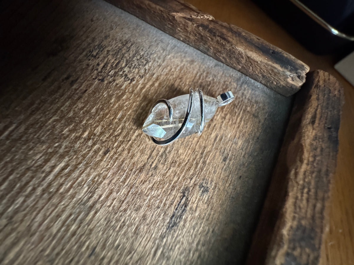 Faceted rutilated quartz in sterling silver pendant