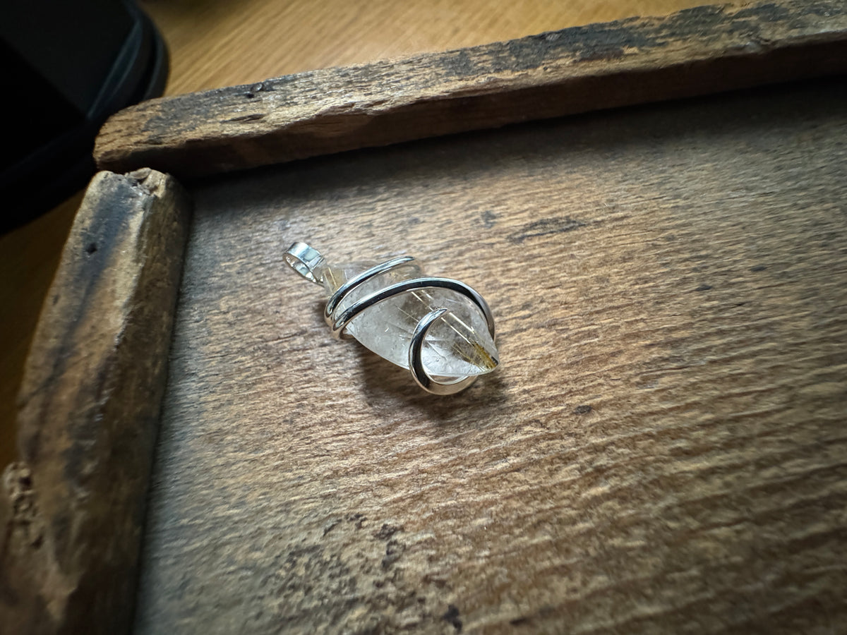 Faceted rutilated quartz in sterling silver pendant