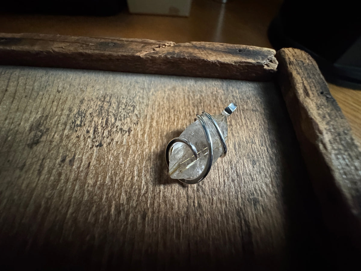 Faceted rutilated quartz in sterling silver pendant