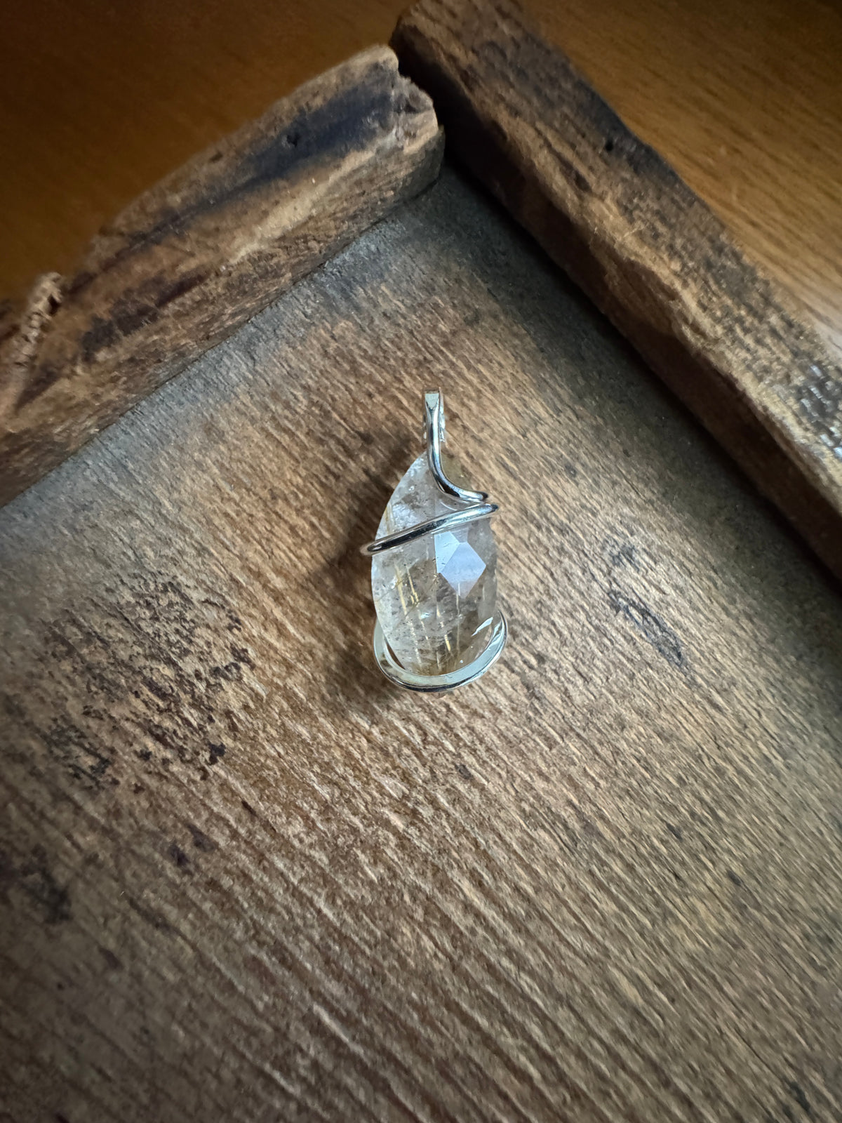 Faceted rutilated quartz in sterling silver pendant