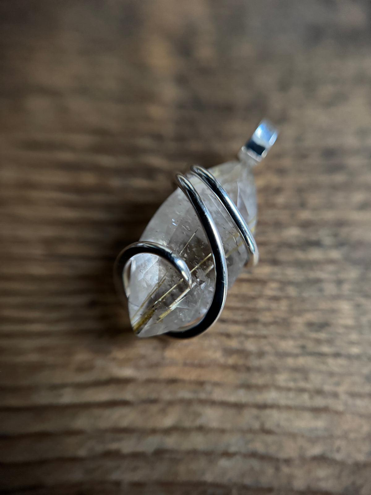 Faceted rutilated quartz in sterling silver pendant