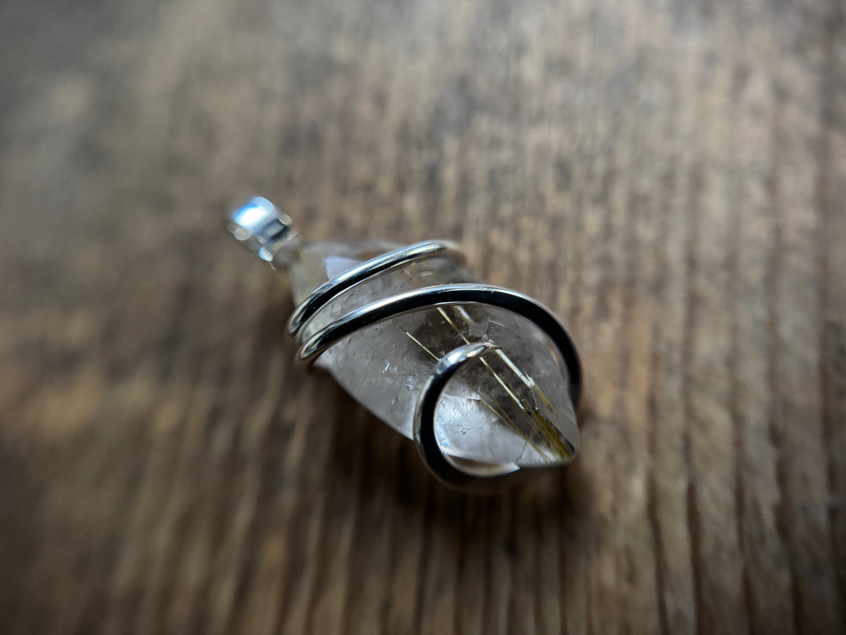 Faceted rutilated quartz in sterling silver pendant