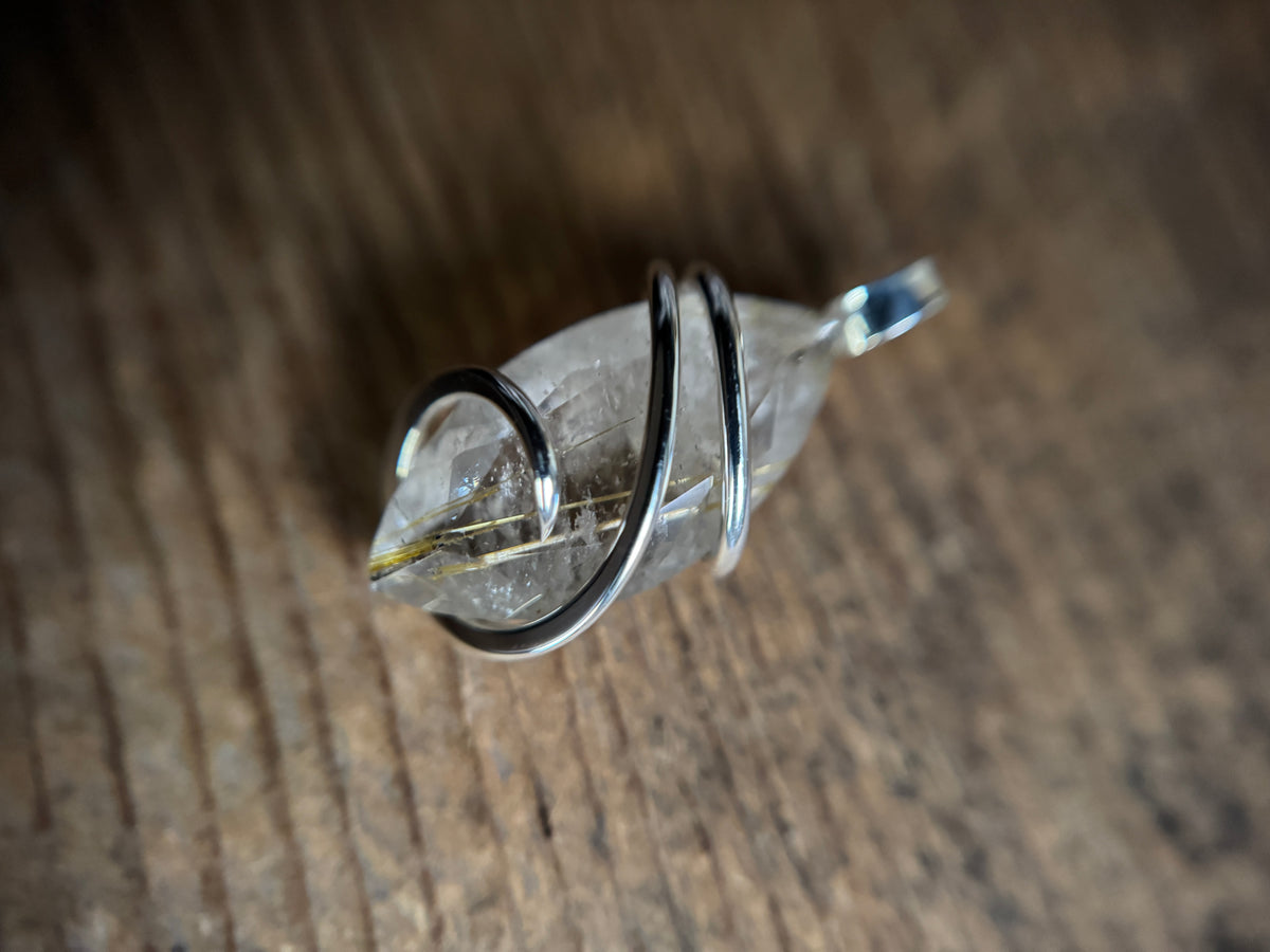 Faceted rutilated quartz in sterling silver pendant