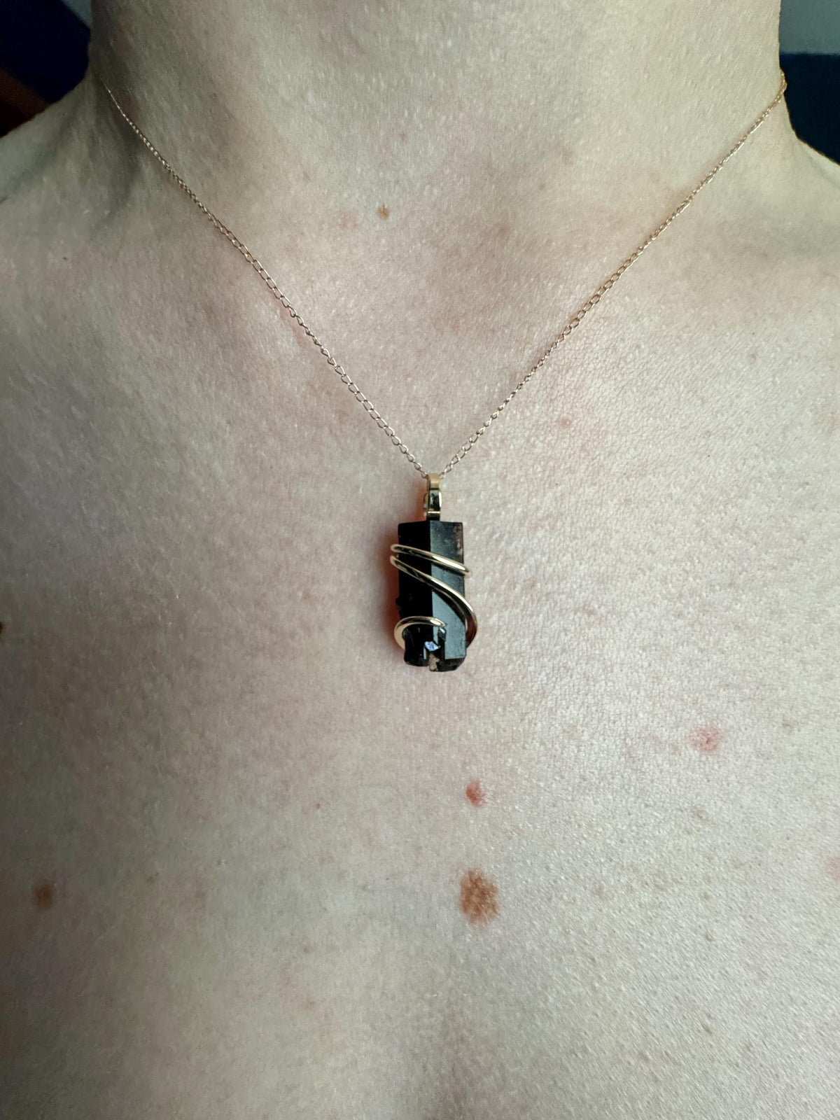 Black topaz crystal in 14k gold pendant