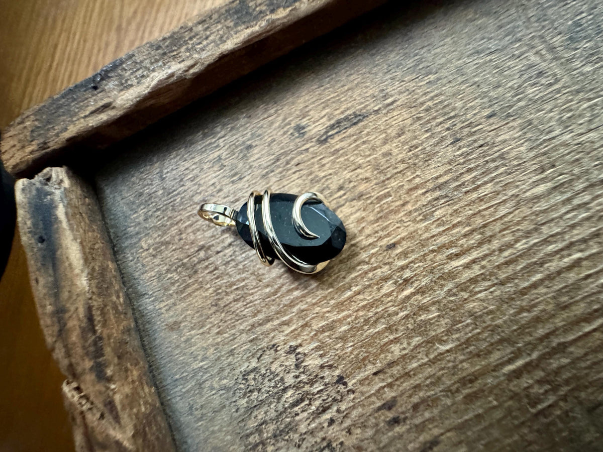 Faceted black tourmaline in 14k gold pendant