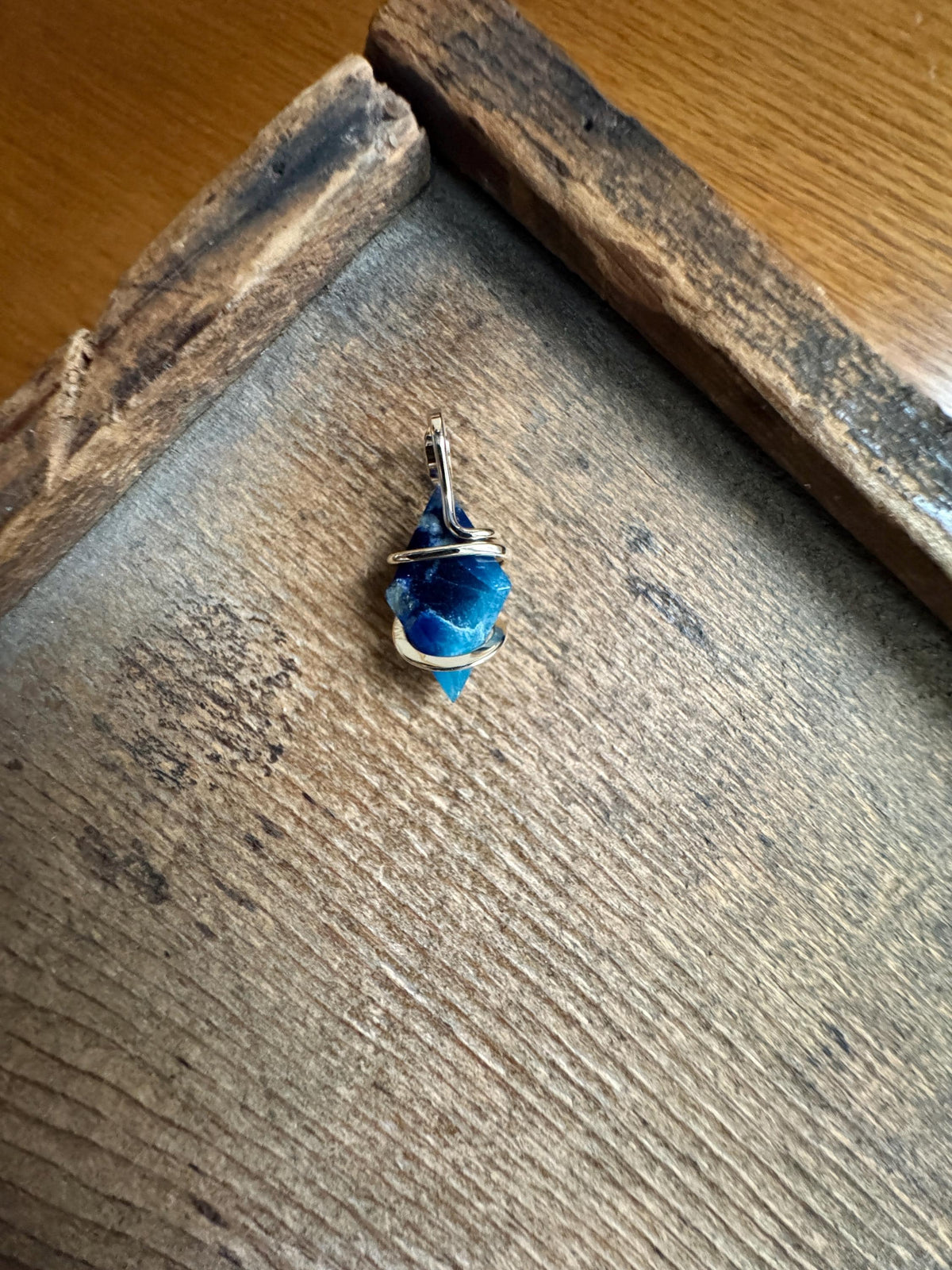 Faceted afghanite in 14k gold pendant