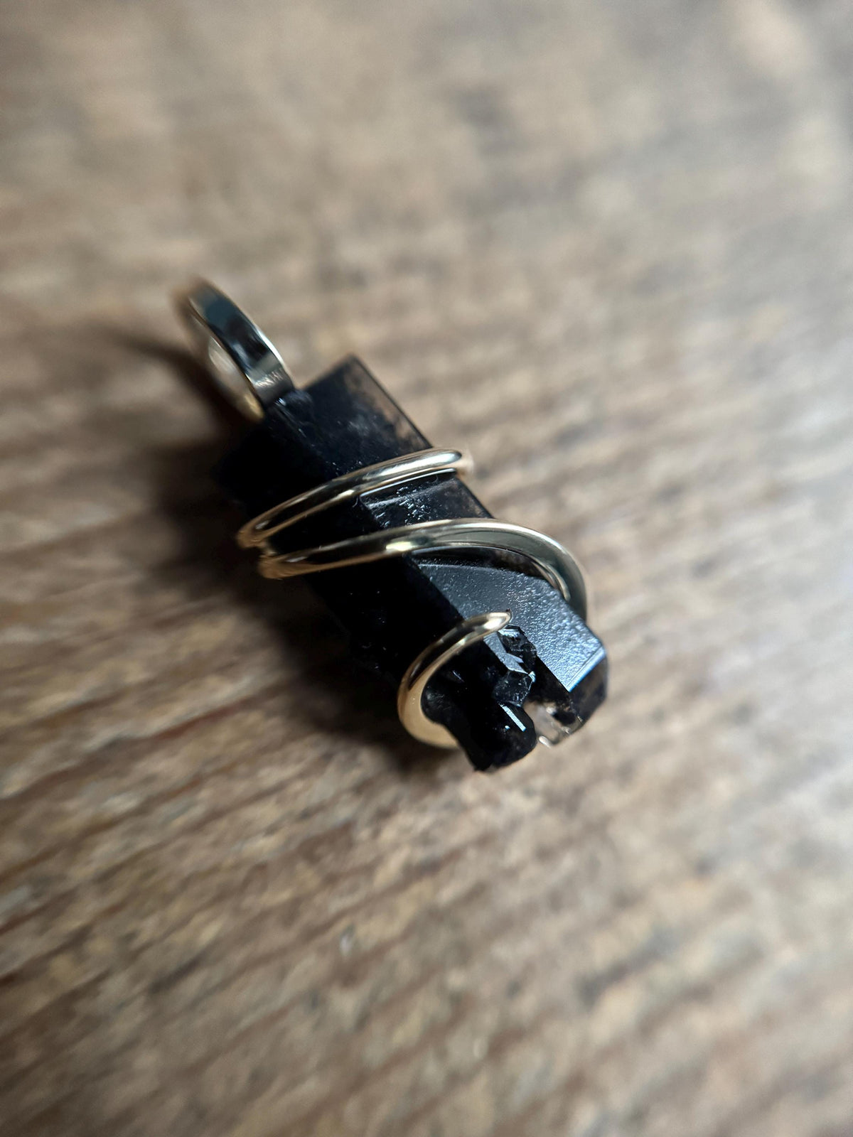 Black topaz crystal in 14k gold pendant