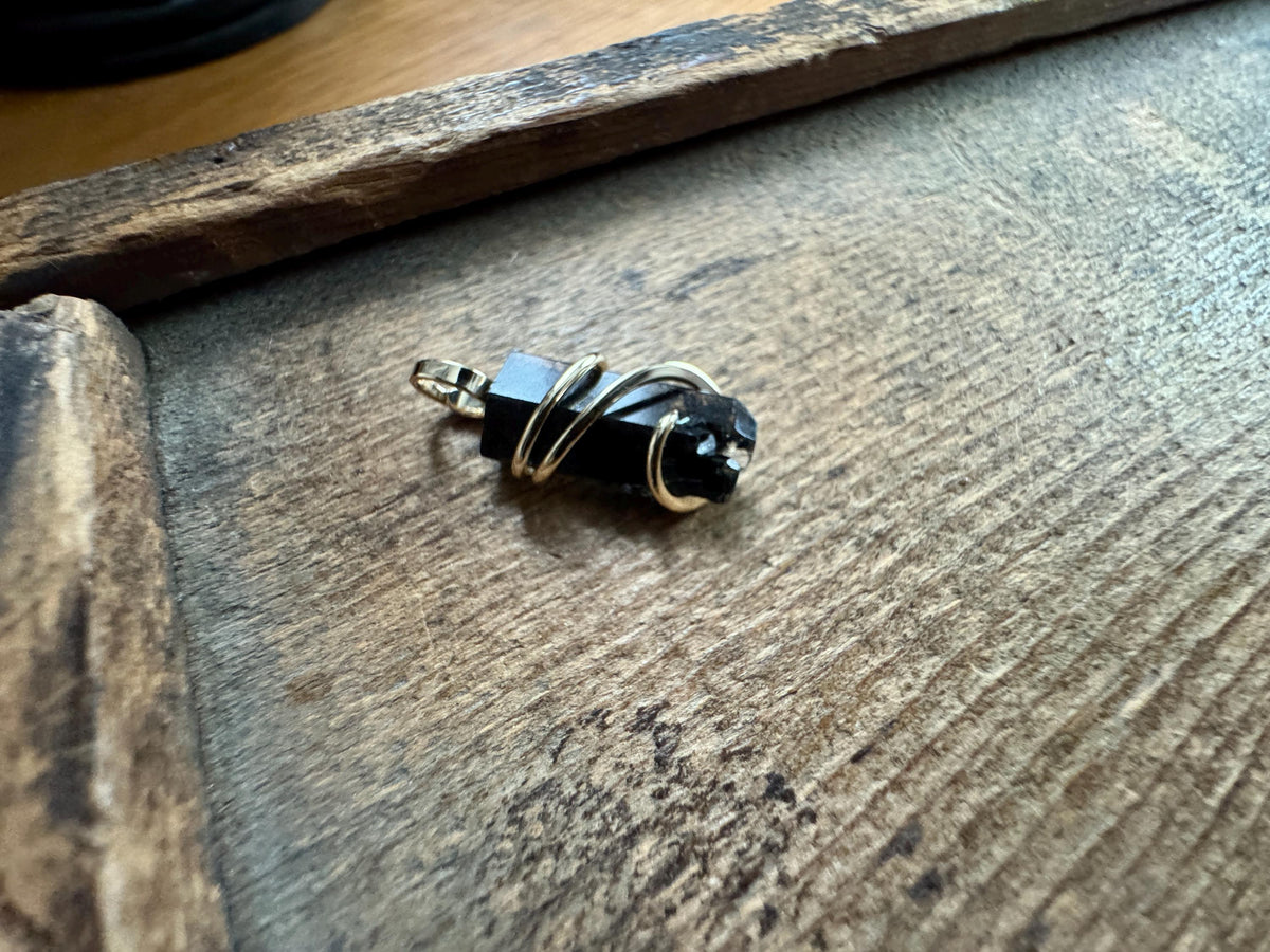 Black topaz crystal in 14k gold pendant